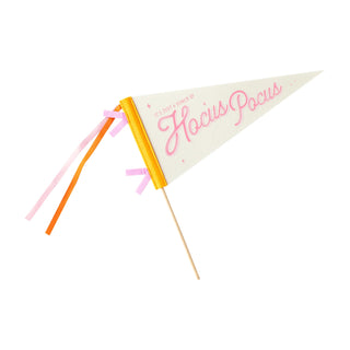 Introducing the Hocus Pocus Felt Banner by My Mind’s Eye, a small pennant flag featuring the phrase "It's just a bunch of Hocus Pocus" in pink text. This delightful banner comes with yellow, pink, purple, and orange ribbons attached to the stick, making it perfect for adding a touch of whimsy to Halloween parties or any magical gathering.