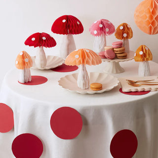 A table full of Meri Meri Honeycomb Mushroom Decorations with a 3D effect on a white tablecloth.