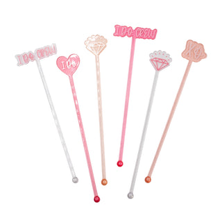 The NPW "I Do Crew" Drink Stirrers set includes six decorative cocktail mixing stirrers with various designs and text such as "I Do Crew," "XO," and "I Do," featuring heart and diamond shapes. Perfect for adding a touch of fun to any bachelorette party!