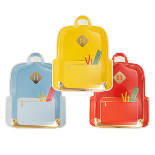 Introducing the My Mind’s Eye Backpack Plate Set: a delightful collection of three colorful paper plates shaped like backpacks—one blue, one yellow, and one red. Each plate features a pocket with a playful pencil and ruler design, making school lunches more fun as you head back to class.