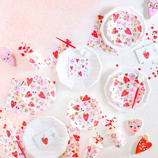 A Valentine's table setting with plates, cups, and gold foil-pressed heart designs in radiant red. Daydream Society's Heartbeat Gang Large Napkins add vibrant neon accents to this romantic ensemble.