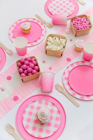 A pink and white table setting with Neon Rose Pattern 7in plates and cupcakes from Oh Happy Day.