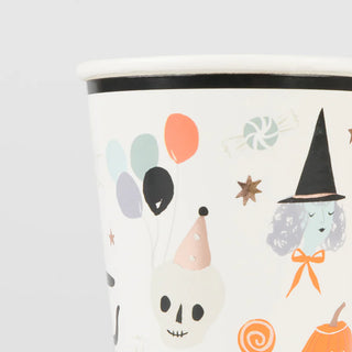 The "It's Halloween! Cups" by Meri Meri feature vintage-look Halloween illustrations on a white background, including balloons, a skull with a party hat, a witch's face, stars, and candy—perfect for adding spooky charm to your party table.