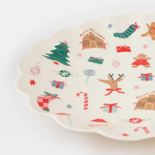 The Melamine Jolly Christmas Reusable Large Plate by Meri Meri is adorned with Christmas-themed illustrations, including a tree, gingerbread, candy canes, reindeer, and gifts on a pristine white background. This festive tableware piece brings cheer to any celebration.