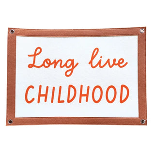 The "Long Live Childhood Banner" by Fun Club features a rectangular sign with a brown border and white center, showcasing the text "Long live CHILDHOOD" in vibrant orange letters. This eco-friendly piece of wall art combines charm with sustainability, being expertly crafted from recycled plastic.