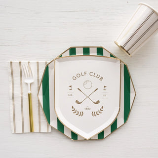 An elegantly set table with Bonjour Fête's Le Golf Small Plates, including a geometric green and white plate made from eco-conscious materials, striped napkin, gold cutlery, and a.