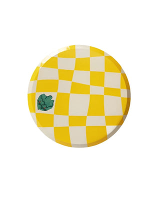 A round plate with a yellow and white checkered pattern and a small green decorative element in the corner on a white background, perfect for adding a touch of simple birthday party decor. Made from sustainable FSC paper, these Little Chef Checkered Paper Dinner Plates by Pop! Party Supplies are both stylish and eco-friendly.