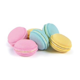 A pile of Fred and Friends' Macaron Erasers in pastel shades of pink, blue, and yellow arranged on a white background. These delightful, BPA-free creations are even strawberry-scented!