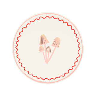 The Merry Mushrooms Side Plates by Meri Meri feature a circular emblem showcasing three mushrooms at the center, encircled by a wavy red border and accented with gold foil details against a light-colored background.