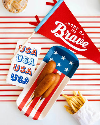 A tray of hot dogs and french fries on a My Mind's Eye USA Paper Guest Towel Napkin.