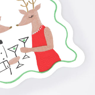 Presenting the Mr. & Mrs. Reindeer Small Napkins by Meri Meri, featuring an illustration of two deer in formal attire, each holding martini glasses. One reindeer is adorned with a pearl necklace and a red dress, all framed by a wavy green border reminiscent of festive tableware.