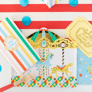 A Daydream Society Off to the Fair Admit One Napkins on a table, featuring gold foil accents.