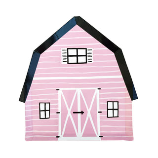 The product, "On the Farm Large Pink Plates" by Daydream Society, showcases an illustration of a charming pink barn featuring white doors and windows beneath a black roof with horizontal stripes, ideal for evoking quaint farm vibes.