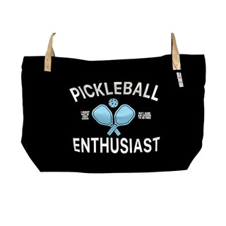 The Pickleball Oversized Tote Bag by Fun Club is a black cotton tote with beige straps. It features the text "PICKLEBALL ENTHUSIAST" along with a design of two paddles and a ball, as well as additional smaller, partially obscured text.