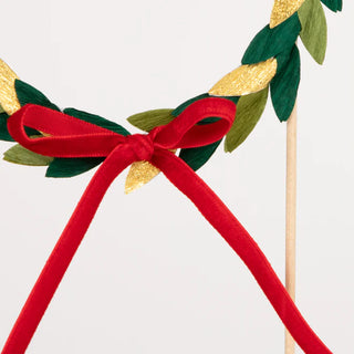 Paper Wreath Cake TopperTransform any cake into a festive work of art with this beautiful wreath topper, complete with an on-trend velvet bow. Simply pop it into the cake for a luxurious loMeri Meri