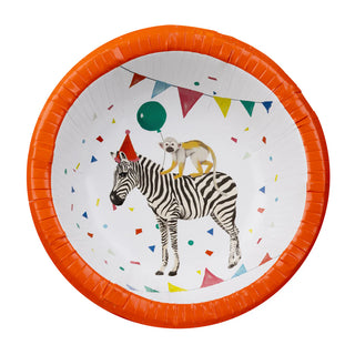 Introducing the Party Safari Paper Bowls by Talking Tables, featuring an orange rim and an illustration of a zebra wearing a party hat, with a lemur holding a balloon while standing on its back. Surrounded by colorful confetti and bunting flags, these bowls are perfect for your next animal-themed party.