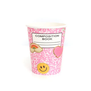 A Kailo Chic Pink Composition Book Paper Cup designed to look like a school supplies classic composition book cover, decorated with patches of a smiley face, heart, and rainbow — perfect for back-to-school vibes.