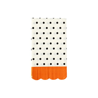 The Polka Dot Halloween Dinner Napkin by My Mind’s Eye features a folded white design with black polka dots and a scalloped orange edge at the bottom, making it perfect for Halloween party decor.