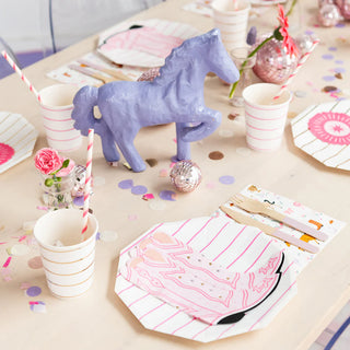 A pink and white table setting with a Pony Tales Large Boot napkins and horse figurine.