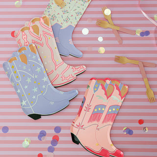 The Pony Tales Large Boot Plates by Daydream Society offer a charming touch, with a pink striped background adorned with scattered confetti and accompanied by plastic cutlery, making them perfect for any rodeo-themed celebration.