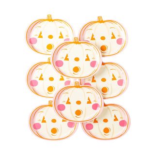 Nine Spooky Pumpkin Plates by My Mind’s Eye featuring painted faces with orange eyes, triangular noses, and round mouths, perfect for serving spooky treats at your Halloween party.