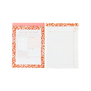 Two planners with a pink and orange border, one designed for setting goals, tracking daily tasks, and organizing appointments with sections for notes, and the other featuring lined pages for additional notes are part of the Notepad Set by My Mind’s Eye.