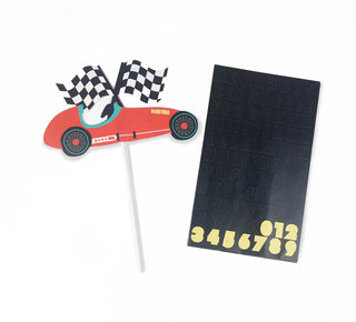 The image displays the Merrilulu Race Car Custom Cake Topper, a miniature red car adorned with black-and-white checkered flags on a stick, ideal for car-themed birthday parties. It is accompanied by a black sticker sheet featuring letters and yellow numbers 0-9.