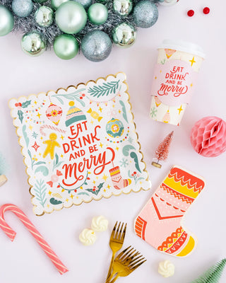 A Christmas table setting with a cup of coffee and mulled wine, adding a touch of holiday magic with My Mind's Eye Retro Christmas Sock Paper Dinner Napkin.