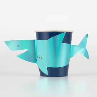 A Meri Meri holographic foil blue Shark Cup featuring a shark, perfect for party guests.