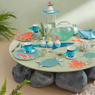 An octopus on a Meri Meri Shark Cups-decorated table.