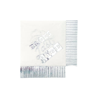 A monochrome image of a single square-shaped, silver-stamped Party West Bride's Last Ride cocktail napkin, with an embossed design and scalloped edges, lying flat against a white background.
