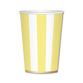 Yellow and white striped paper cup with a gold rim at the bottom, standing upright against a white background. This stylish piece, the Soleil Yellow Cabana Stripe Cup from Bonjour Fête, exemplifies eco-conscious materials while adding a touch of elegance to your gatherings.