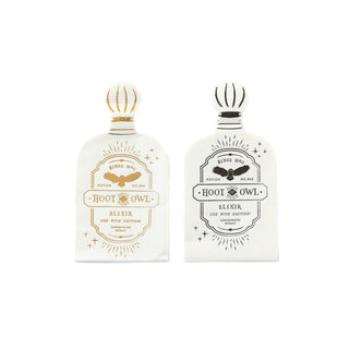 Two white packets labeled "Hoot Owl Elixir" with decorative designs. One packet features gold accents reminiscent of the Spellbound Potion Napkin by My Mind’s Eye, while the other is marked with sleek black accents.
