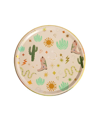 A round beige plate with a southwestern design featuring cacti, cowboy boots, snakes, suns, and lightning bolts on a white background. Perfect for a cowboy party, these Pop! Party Supplies Snake Catcher Western Theme Paper Plates also showcase intricate gold foil details that add an extra touch of elegance to the western theme.