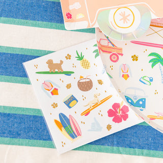 The Surf's Up Large Plates from Daydream Society feature vibrant beach-themed designs including surfboards, a dog, a VW van, a coconut drink, a pineapple, and even a can of Spam on a striped fabric backdrop. Ideal for enthusiasts of beachside surf culture!