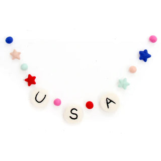 A felt garland celebrating the 4th of July features letters forming "USA" flanked by colorful stars and small pom-poms against a white background, making the Kailo Chic USA 4th of July Felt Garland - Giant Friendship Bracelet perfect Independence Day decor.