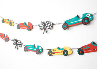 The Merrilulu Vintage Race Car Party Garland features colorful paper cutouts of race cars and checkered flags strung together, creating a vibrant decoration perfect for birthday parties, all set against a white background.