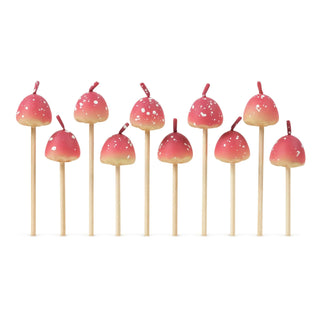 Ten enchanting Mushroom Birthday Candles from Fred and Friends, featuring small, red-topped, mushroom-shaped designs with white speckles and wooden stems arranged in rows, add a magical touch to any decor.