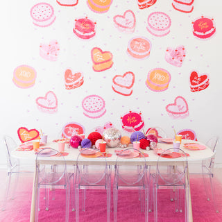 A Victorian-themed Valentine's Day party with pink table and chairs, adorned with Jollity & Co's You're The Cherry On Top Die Cut Cake Large Napkins.