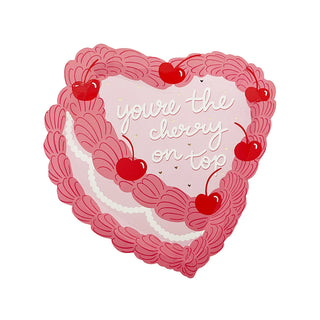 The heart-shaped design with red cherries and pink scalloped edges, reminiscent of vintage Victorian aesthetics, features the phrase "You're the Cherry On Top." This beautifully encapsulates the essence of Jollity & Co's romantically sweet dessert plate collection.