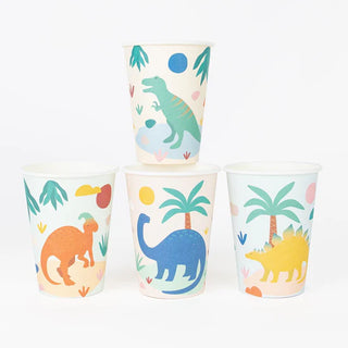 Three recyclable Dinosaur Jurassic Cups from My Little Day are arranged against a white background, featuring vibrant graphics of t-rex, triceratops, and brontosaurus amidst palm trees and tropical foliage.