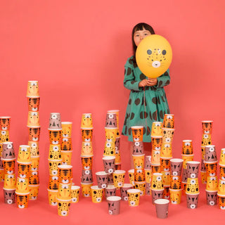 A cute little girl stands in front of a pile of My Little Day Mini Felines Cups.