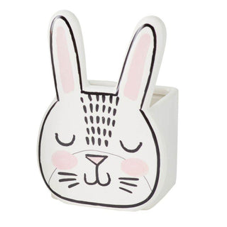 A BASHFUL BUNNY POT shaped planter with hand-painted details on the pink face by Accent Decor.