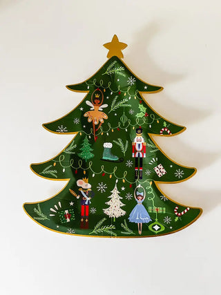 A green Christmas tree plate adorned with ornaments by Josi James.