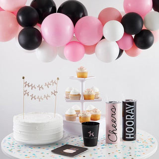 A table adorned with colorful balloons and delicious Party Animal Cocktail Party Cups by Slant.