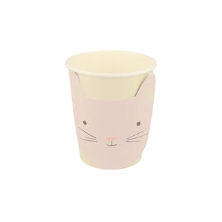 A cute, smiling kitten-face illustrated on a pastel pink, sustainable FSC paper Meri Meri Kitten Cup with a cream-colored lid.