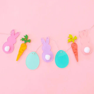 EASTER ICON GARLAND5 Ft garland comes with 7 acrylic die cut Easter icons featuring bunnies, carrots and eggs. Acrylic bunnies feature pompom bunny tails. Garland is pre-strung with piKailo Chic
