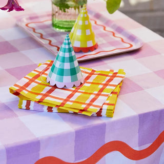 A pink gingham tablecloth with Everyone's Welcome Yellow Napkins, perfect for a spring/summer party from Talking Tables.