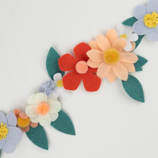 Felt Flower GarlandThis fabulous felt flower garland, with pompom centers, is a stunning and sustainable way to decorate your party table, party room or to use as a home decoration. ItMeri Meri