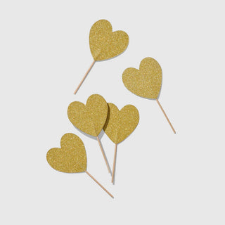Heart Mini ToppersThese toppers are a cupcake's best friend, but they also look great skewered in apps or garnishing drinks.

Double-sided gold glitter hearts
Each heart measures apprCoterie Party Supplies
